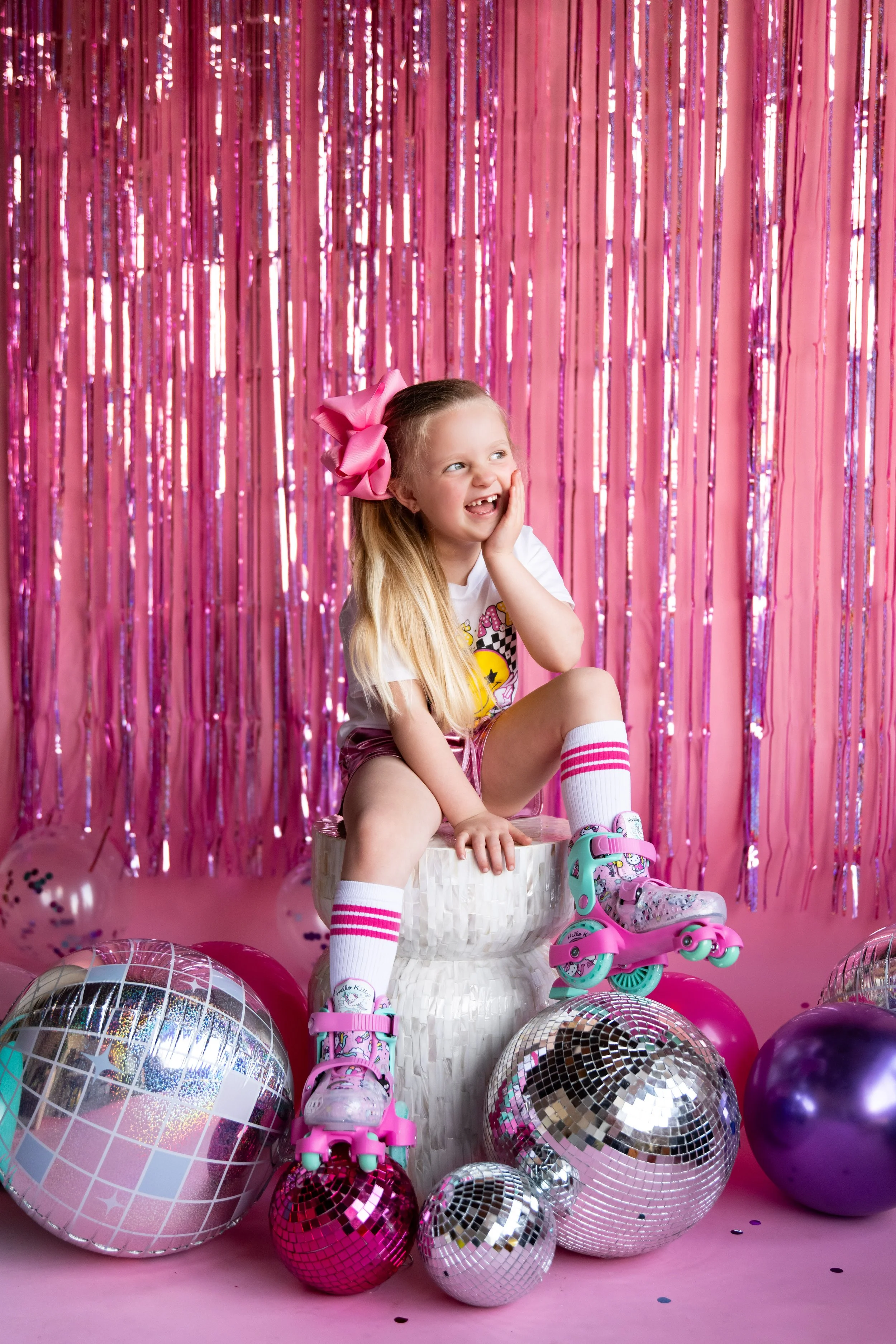 Five-year-old girl laughing in roller skates during a birthday milestone session at Highlight Studio in Knoxville, Tennessee