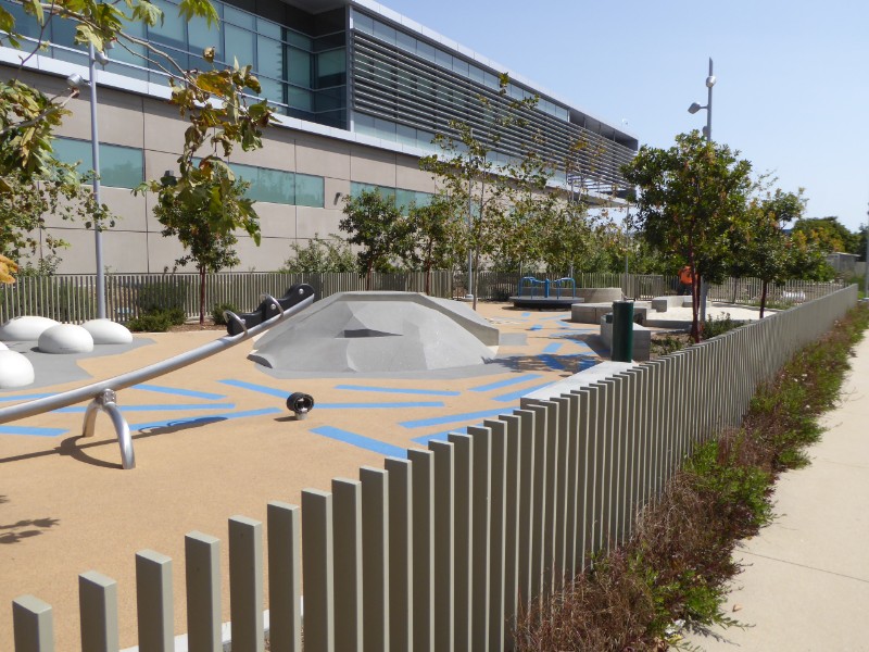 Playground, steel fence & wall of Metro maintenance building