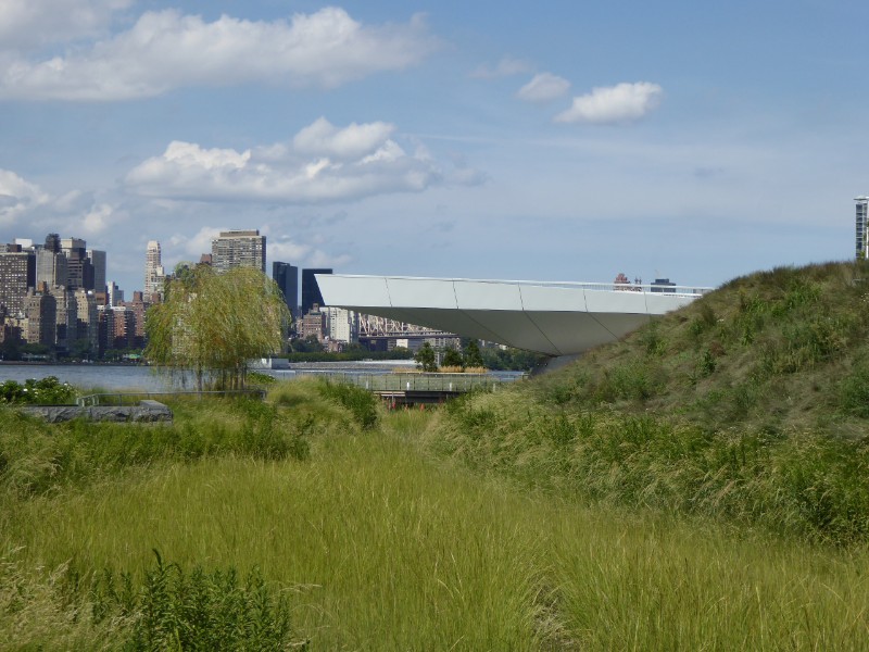 View across wetland &amp; observation deck seen against Manhattan skyline