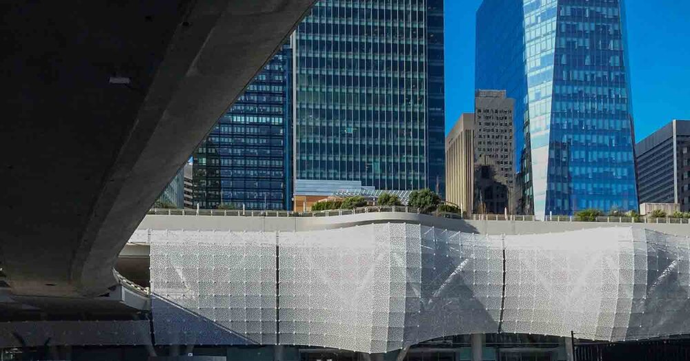 Perforated metal screen &amp; elevated bus roadway connection to transit centre