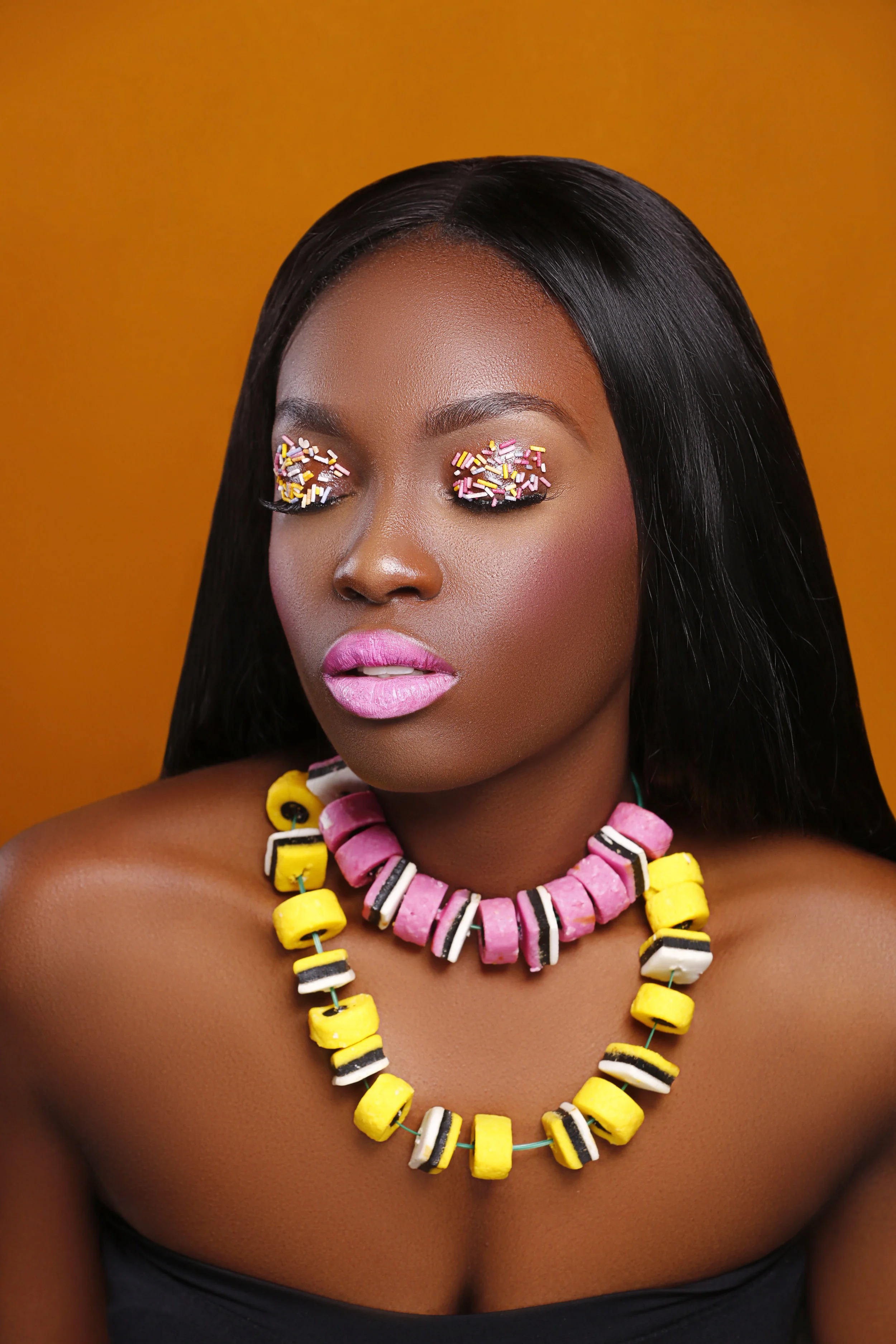 This was my 2nd favourite look from this shoot. To make the necklaces, i used Garden Wire and Liquorice sweets. I simply fed the sweets through the garden wire until i had a good size to go around the neck. I then tied it to the size this partcular model while we where on set. On the lids i again used vaseline as a base and used my fngers place the sprinkles onto the lids
