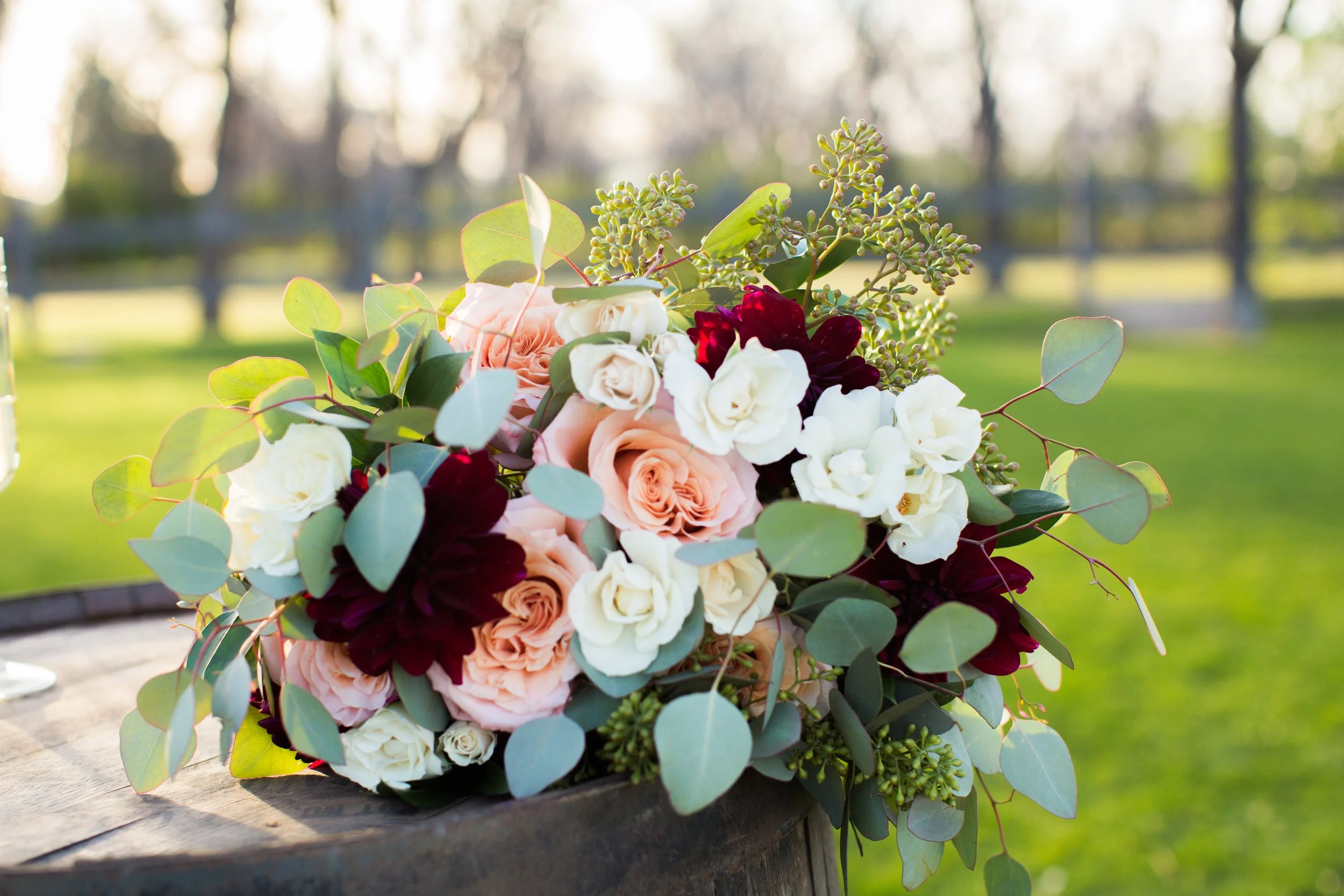 Wedding flower bouquet on whiskey barrel grass