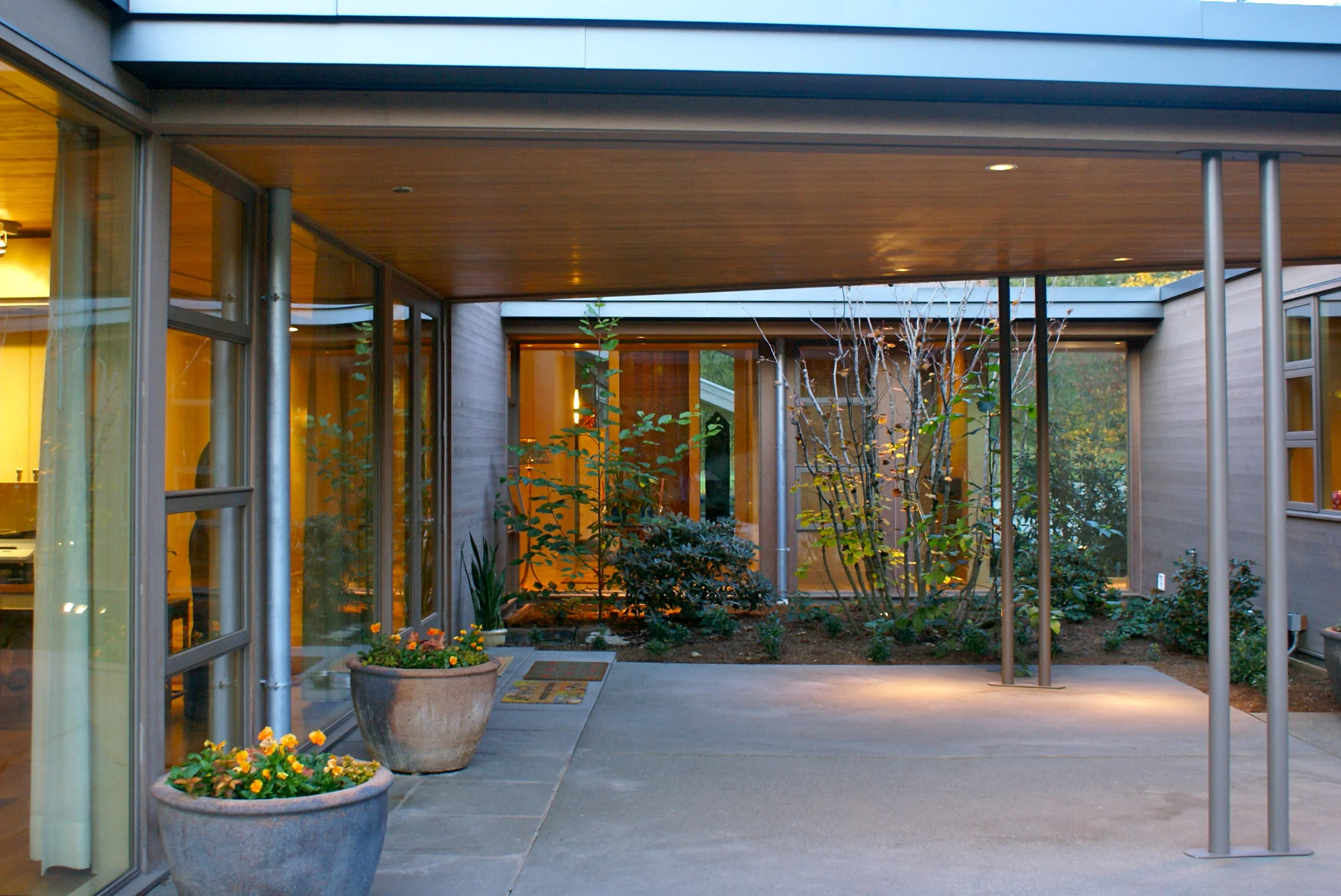 The terrace roof here is pulled away to allow for landscape along the walkway.