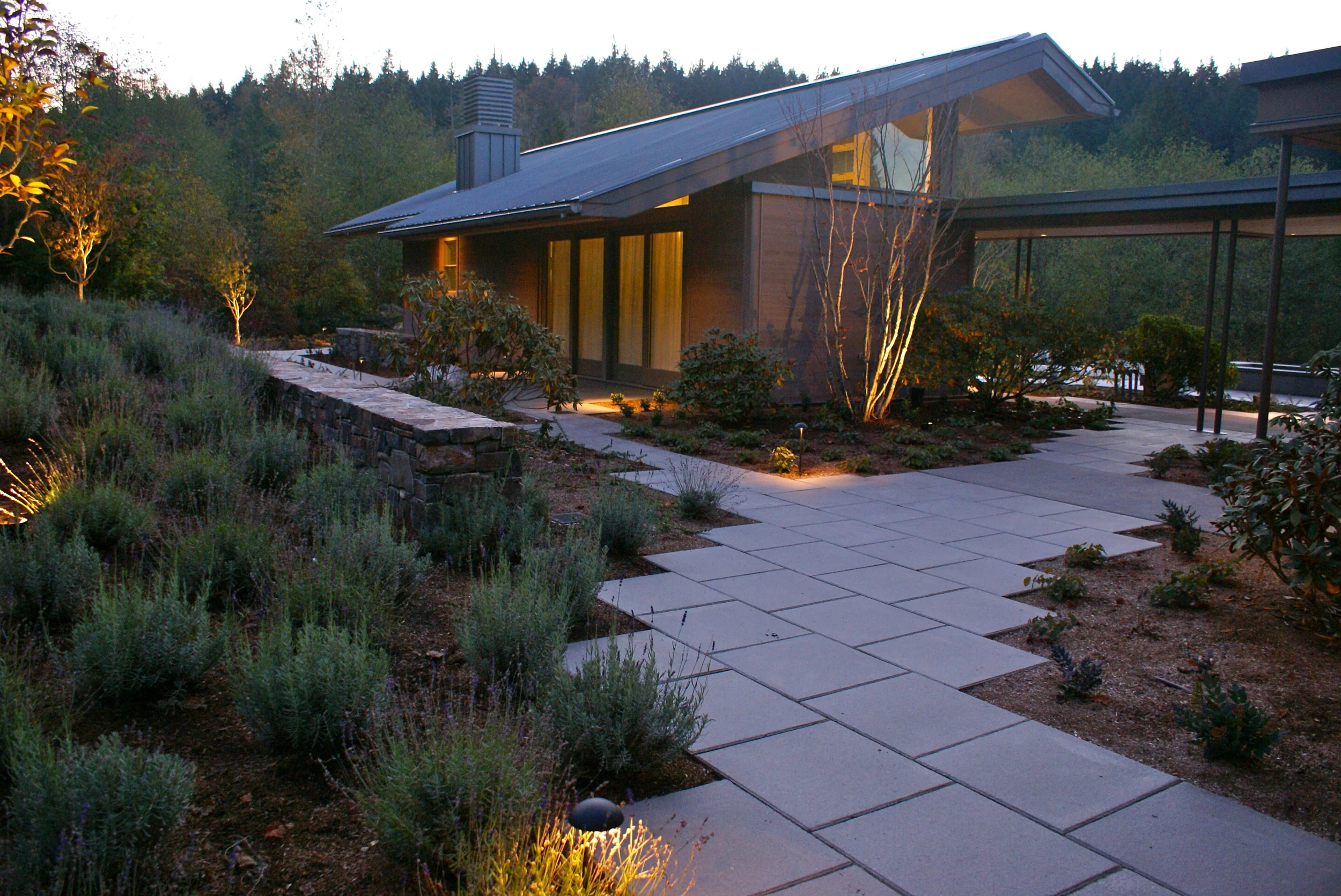 Landscaping flows between the main house and the guest house. A terrace roof connects them together.