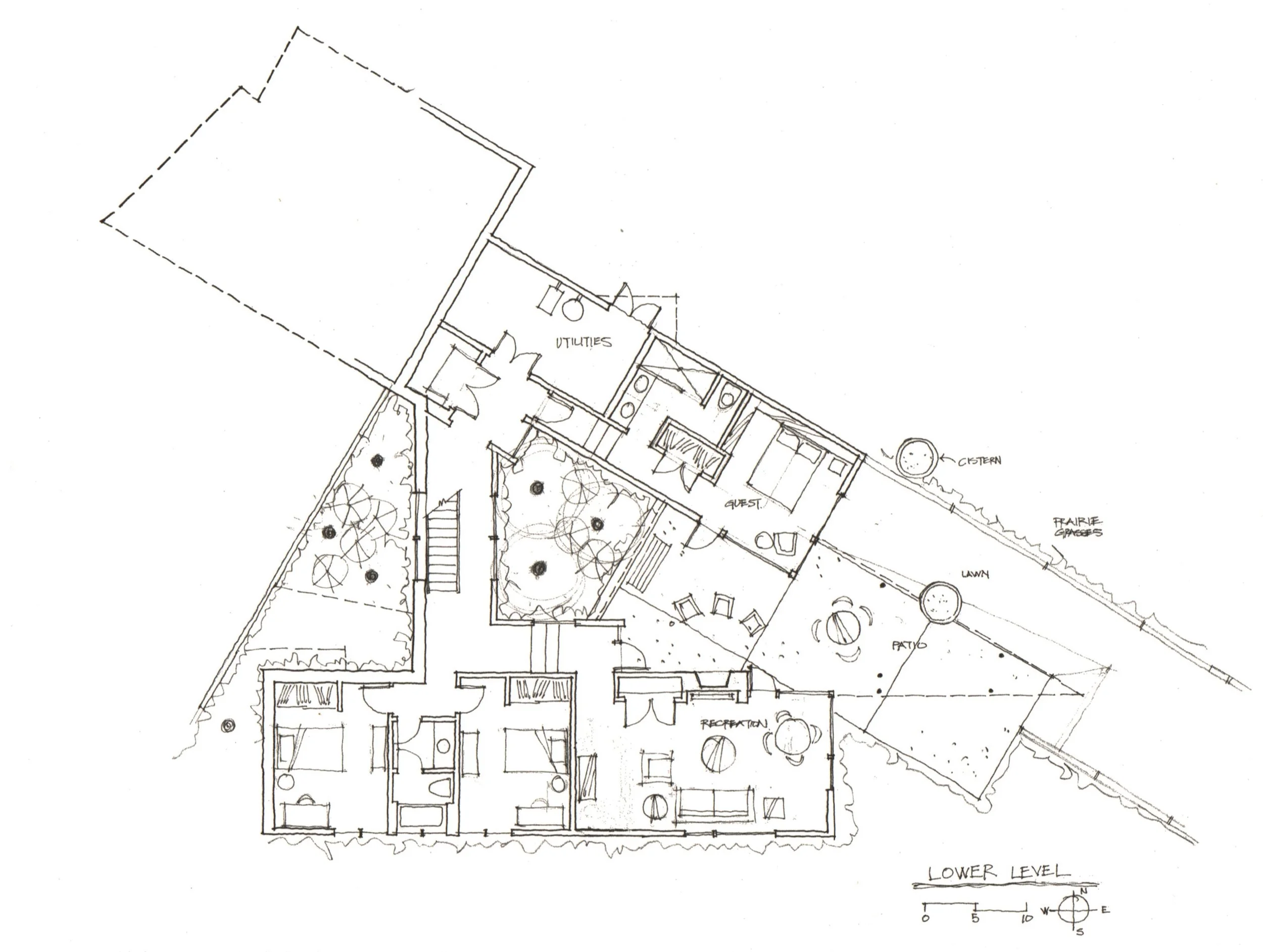 The lower level opens out to a terrace. Aspen trees are planted in the beds either side of the house staircase. A adjacent small manicured lawn extends out toward the view. Rainwater is collected by two large cisterns.