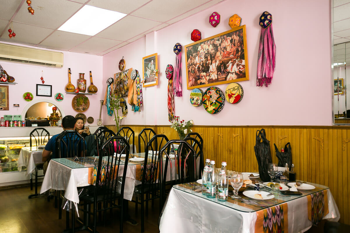  Inside the walls are prominently decorated with traditional Doppa hats, scarves, paintings, and items iconic to Uyghur heritage. 