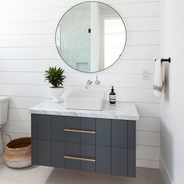 Happy Friday...guest bath goodness from our project Newport Heights 🙌✨ #shiplap #finishcarpentry #vgroove #customvanity #roundmirror #bathroomdesign #interiordesign #designbuild #claytonbuilders #customhome #newportheights 📸: Luke Lighthouse