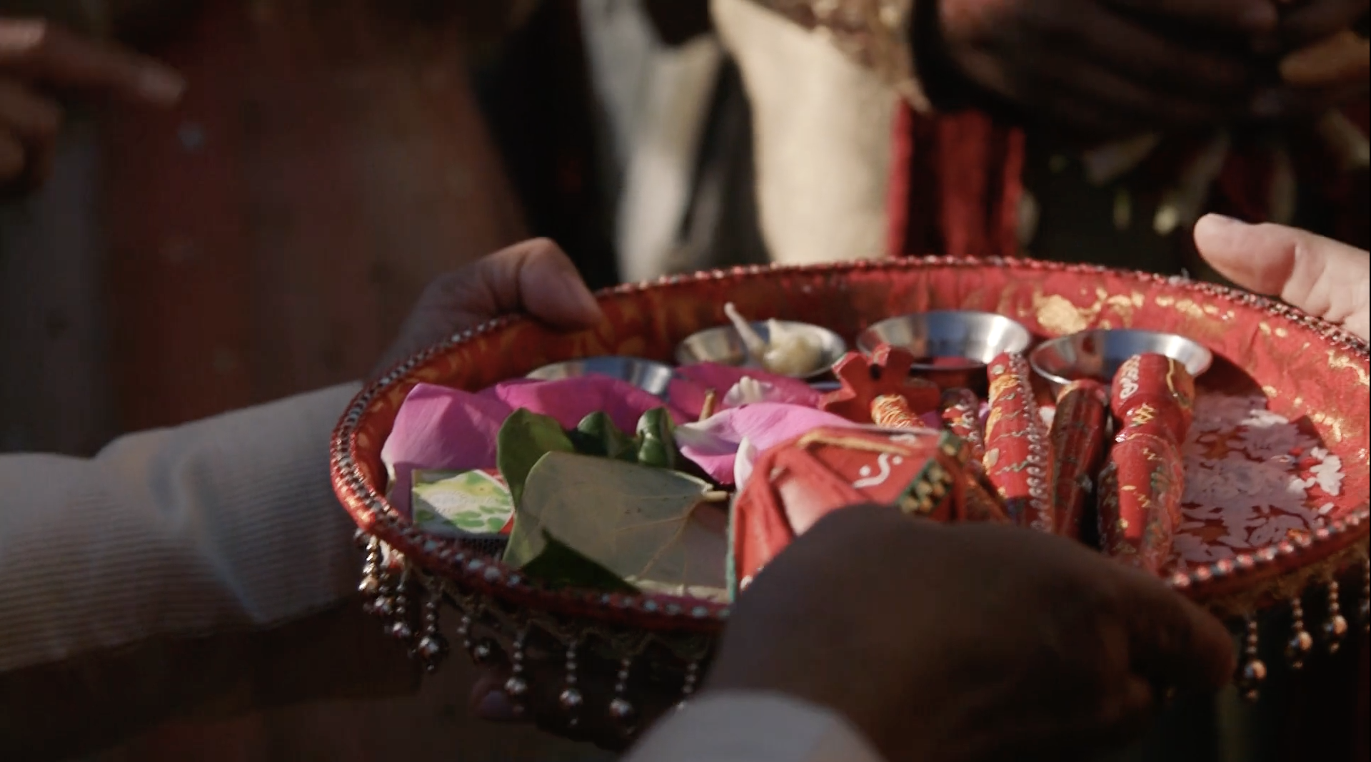 indian-wedding-red-tray-with-flower-petals.png