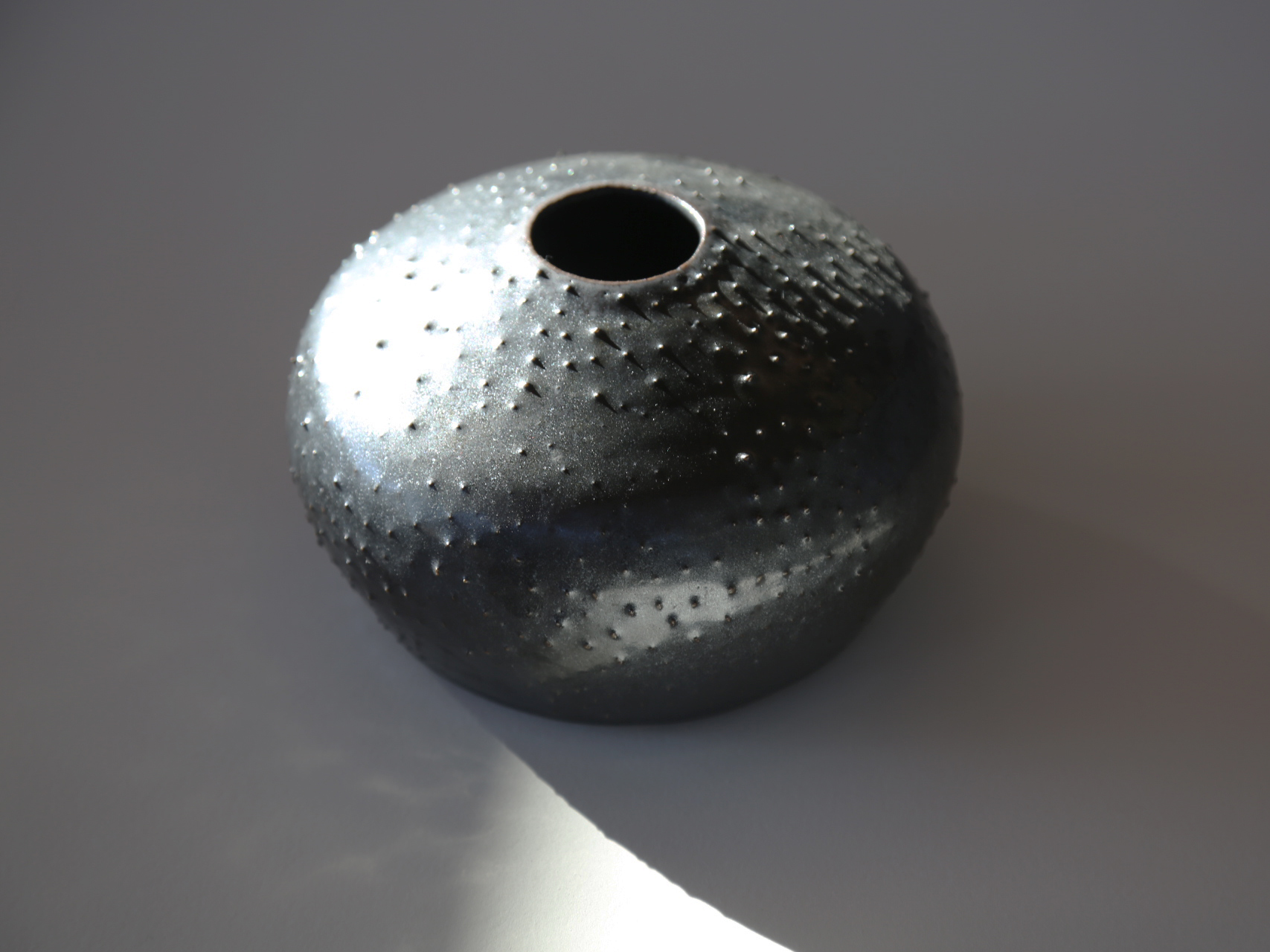 Black metal dotted pot