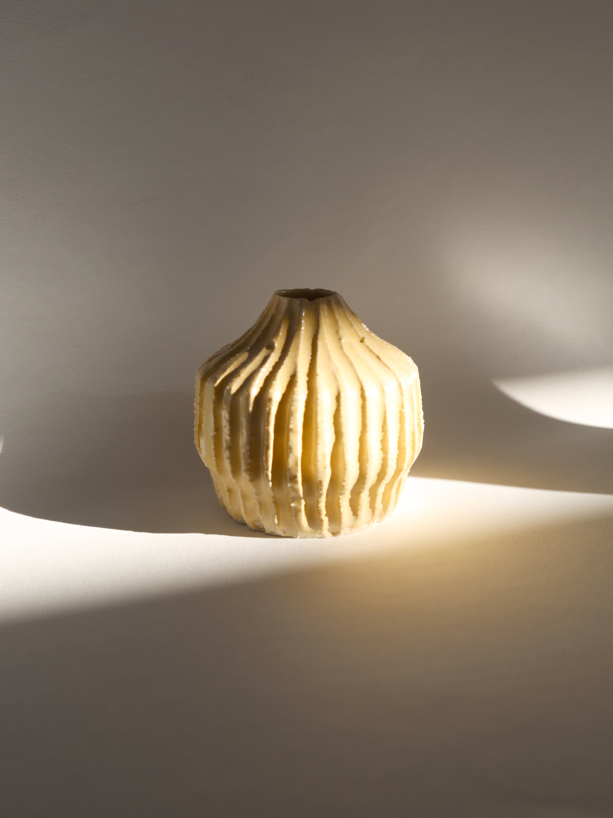 Notched yellow bud vase