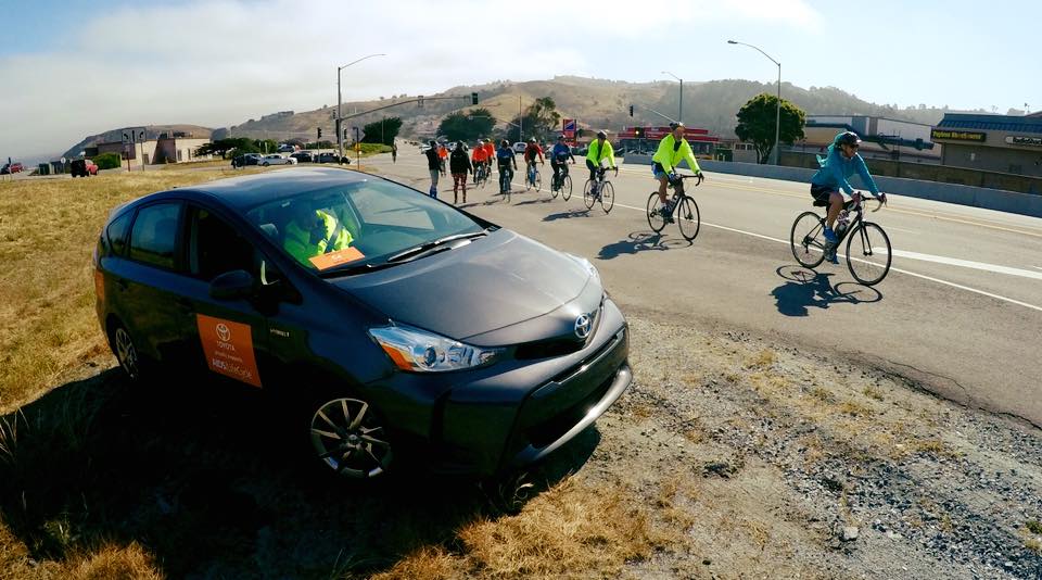 Safety Prius on side of road with cyclists.jpg