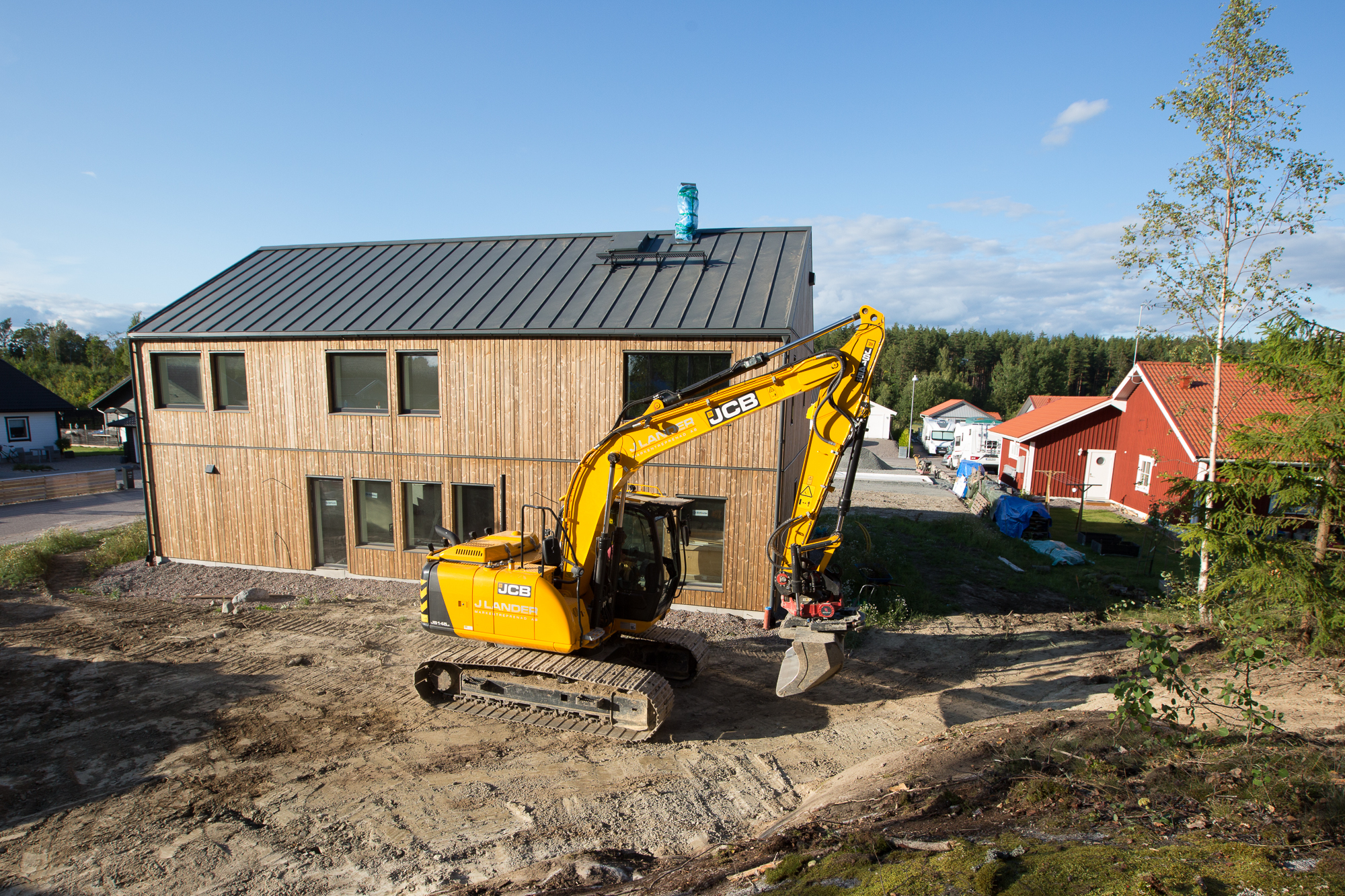  Framsidan av huset där en stor altan och gräsmatta kommer ligga. 