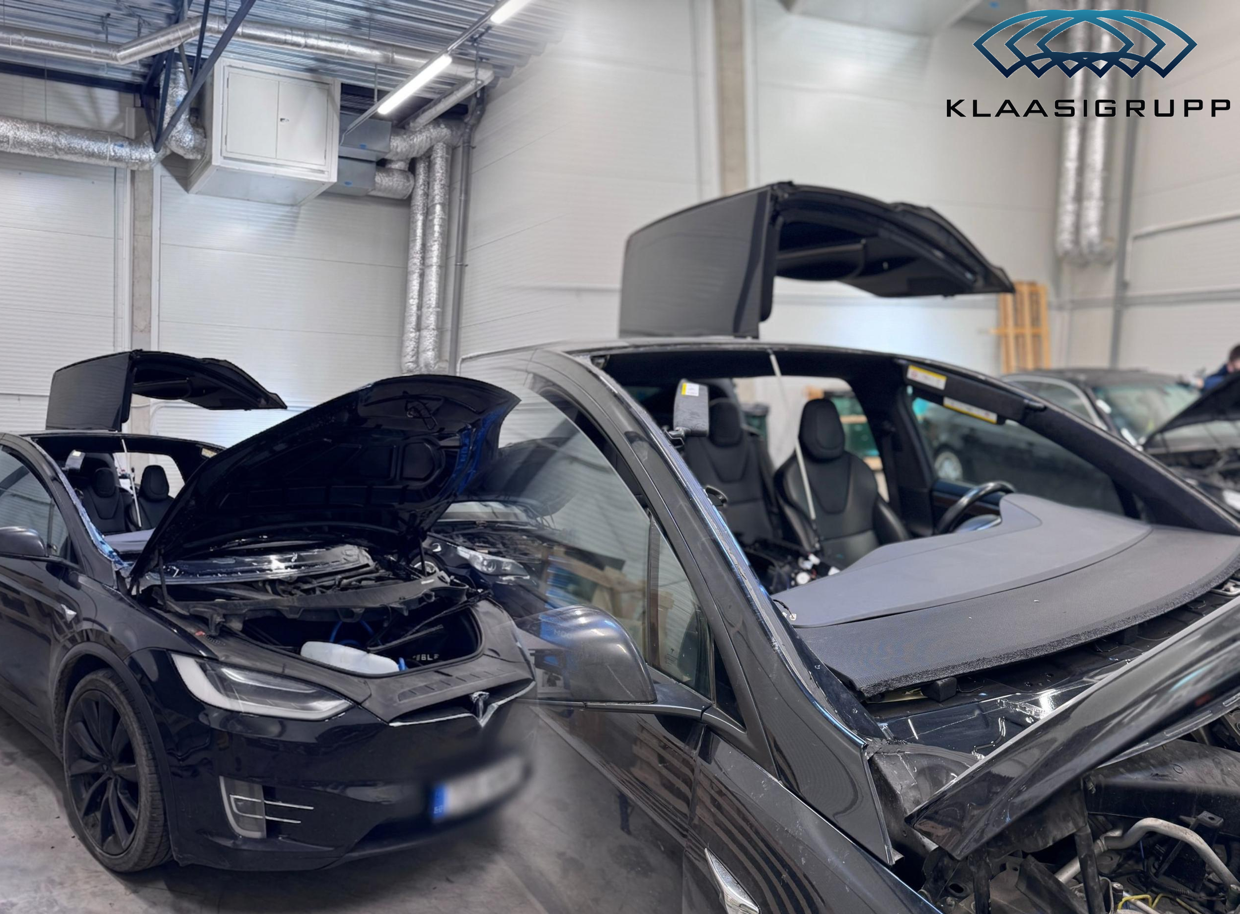 Black Tesla cars with raised rear hoods inside a warehouse or garage, exhibiting electric vehicle features.