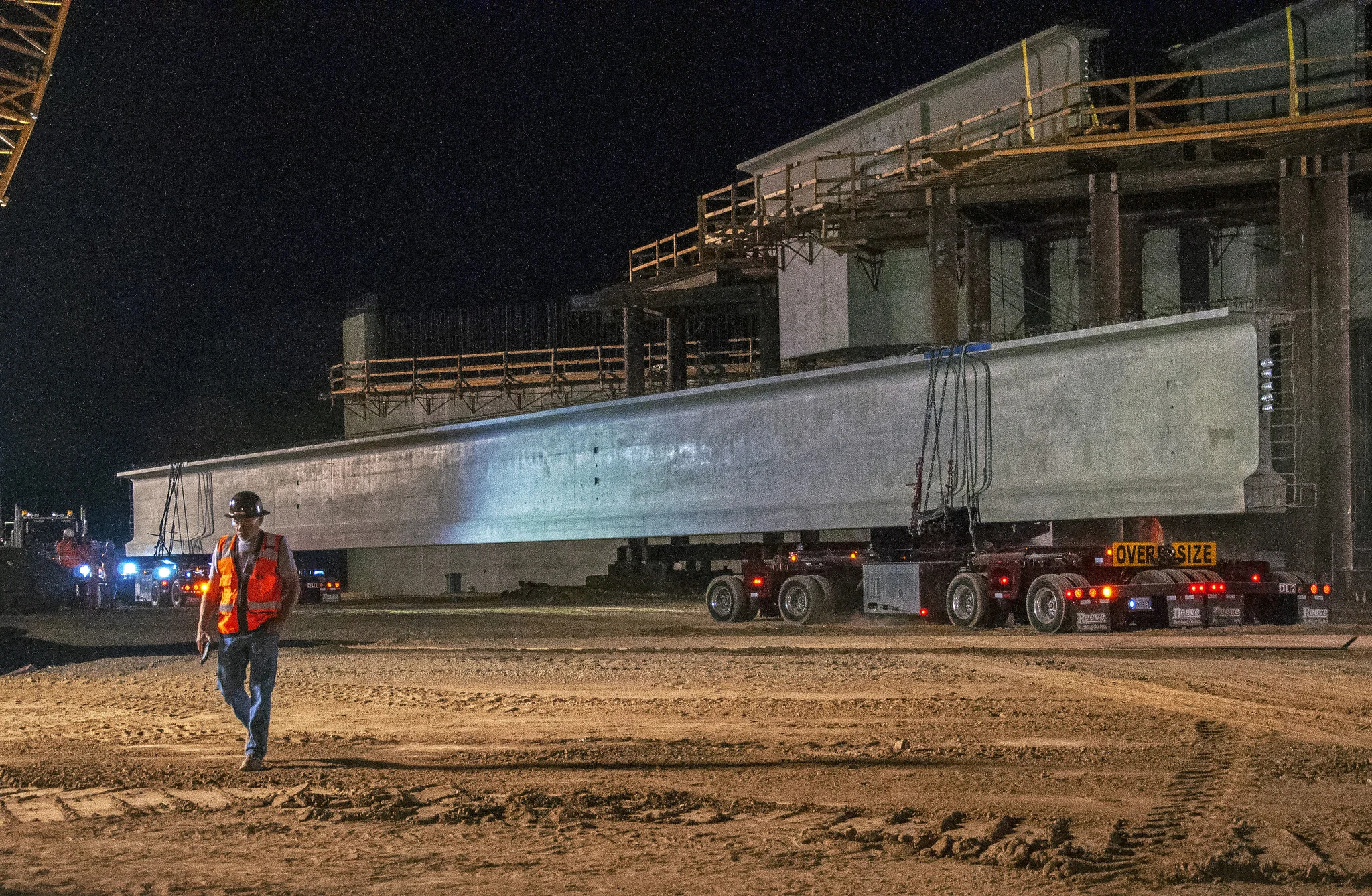 Setting two massive concrete girders over BNSF tracks in Madera County ( Photo courtesy California High-Speed Rail Authority )