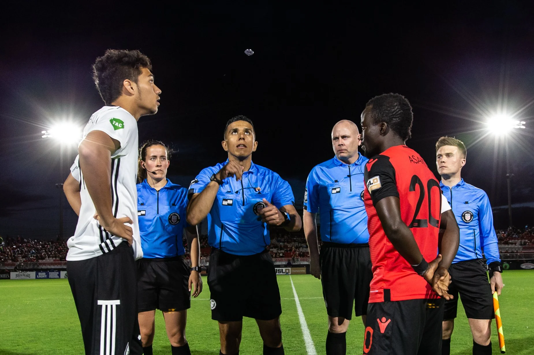 Melissa (far left) and crew conduct the coin toss at a Phoenix Rising FC match.