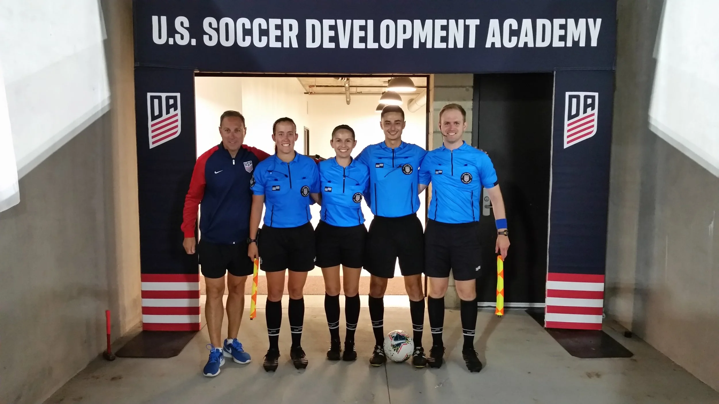 Melissa (far left referee) and crew pose with Rick Eddy, USSoccer Director of Referee Operations.
