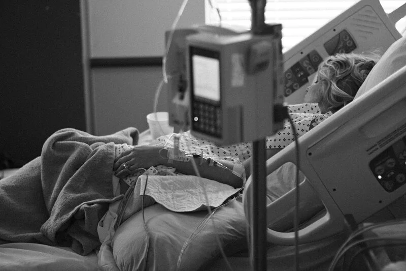 Woman lying in hospital bed