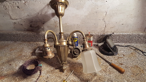 A vintage light fixture in Michael's workshop about to be worked on