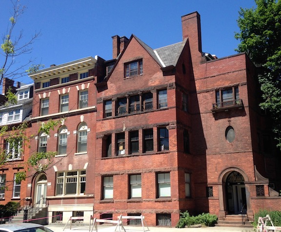 A handsome red brick colonial revival (left) next to a handsome richardsonian romanesquw