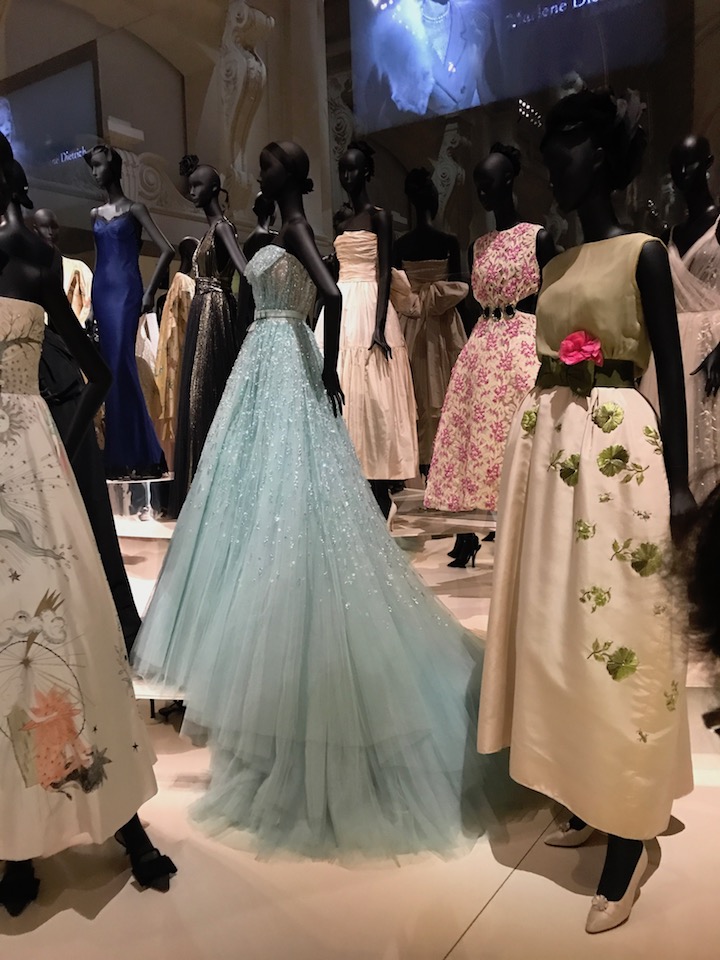 In this tableau, one can see dresses worn by Liz Taylor (front right) and Princess Diana (upper left)