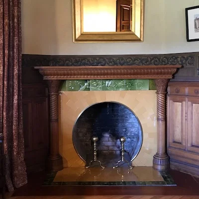 This mantel in the small parlor features an opening inspired by an Asian Moon Gate, and till decorated with birds and cherry blossoms