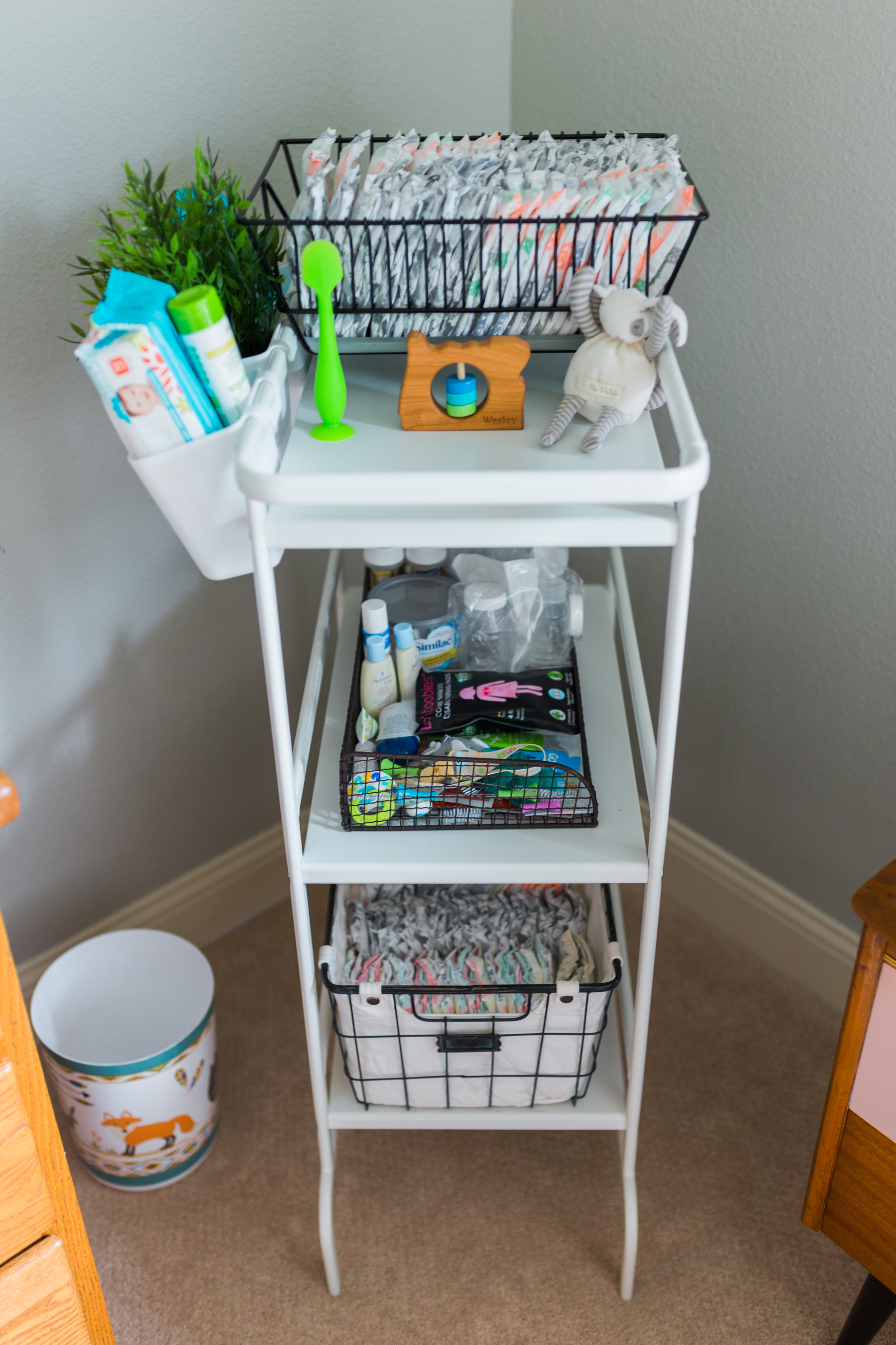 I'm pretty proud of this silly thing. I looked on Pinterest for changing station organization and there's a different IKEA caddy all over the place, but it didn't come in a color I liked! I found this one in their laundry area for half the price (and it's larger), the diapers on top are in a plate drying rack (ha!) and the little buckets on the side and baskets were add-ons. It's filled with all sorts of diaper supplies and TONS samples I've received from various companies (all of the diapers and wipes in the caddy were even free!). 