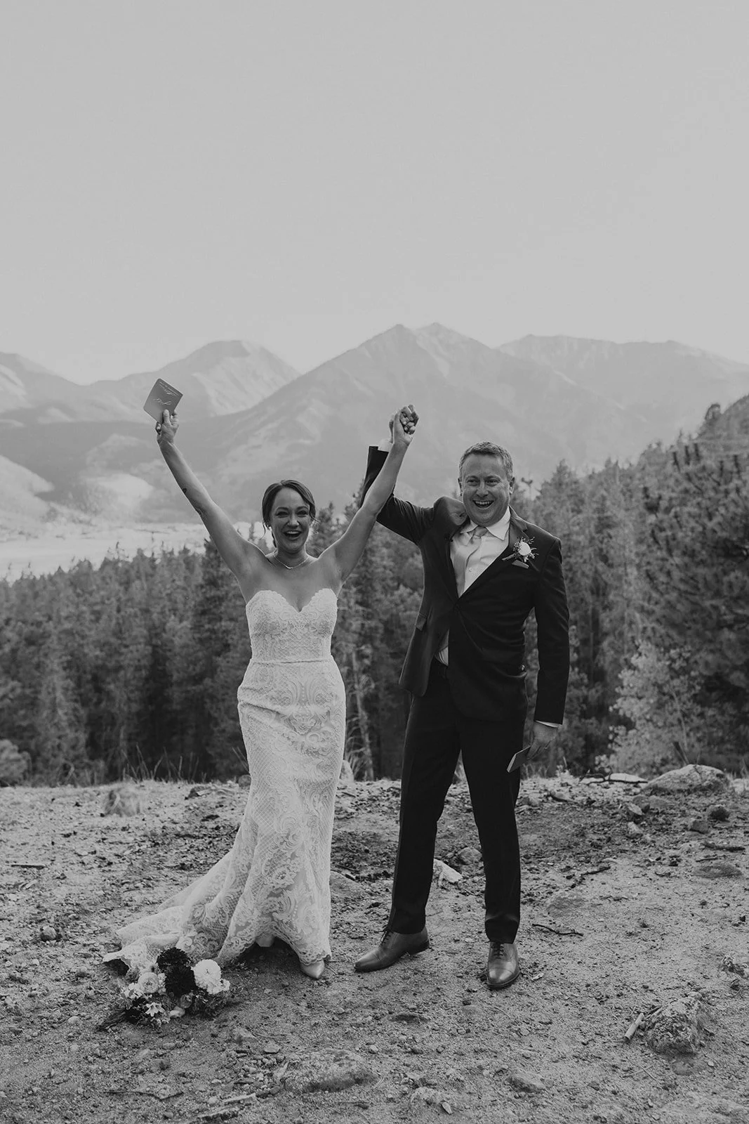 Bride and groom standing above the upper Twin Lakes during a fall elopement in Colorado