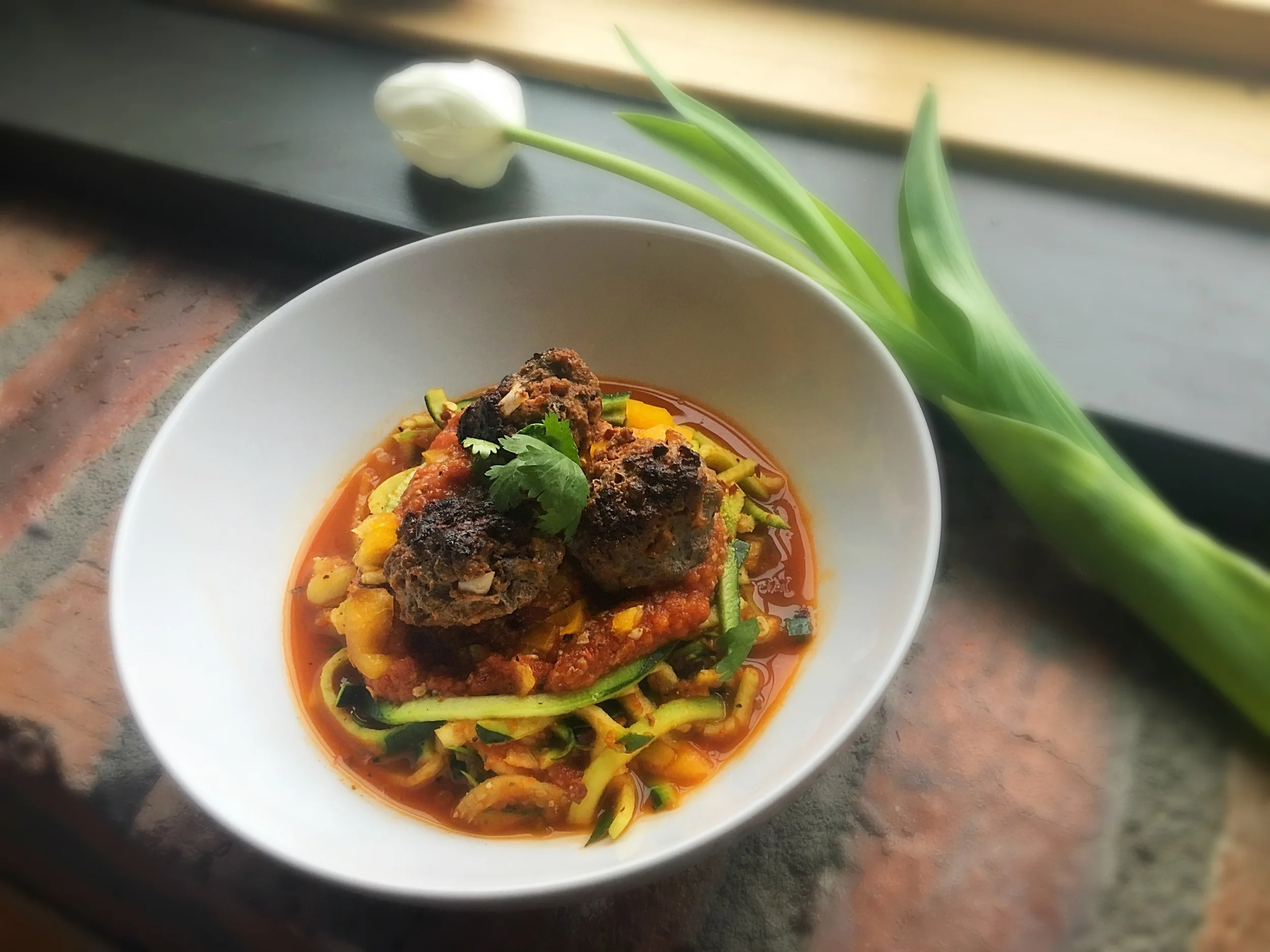 Bison Meatballs with a spicy mushroom marinara served over zucchini noodles 