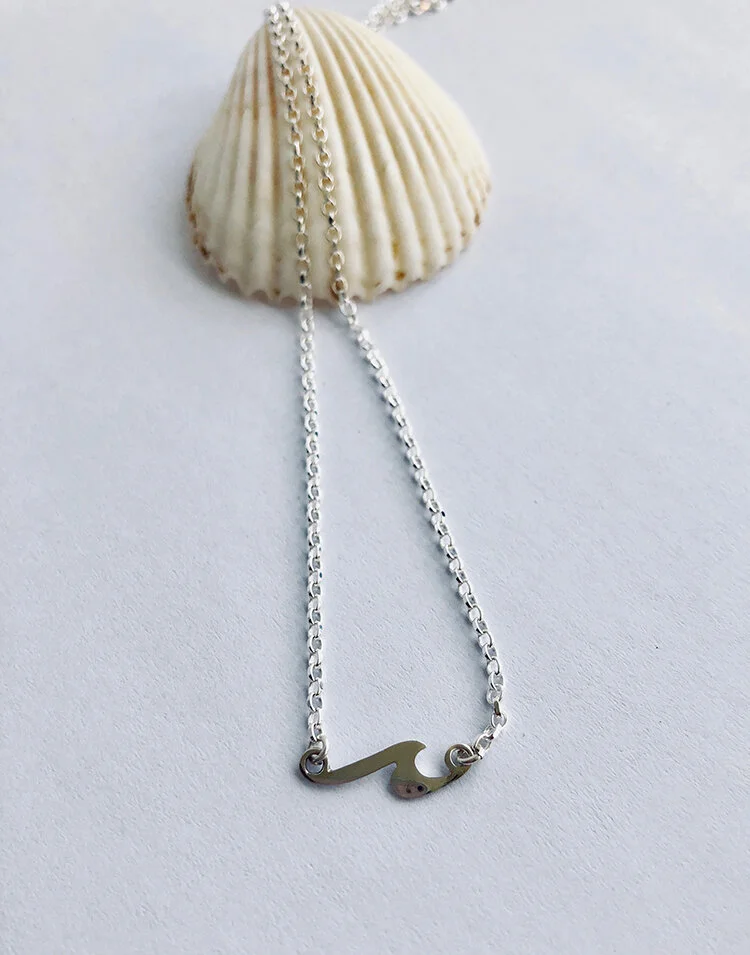 mini wave necklace on shell.jpg