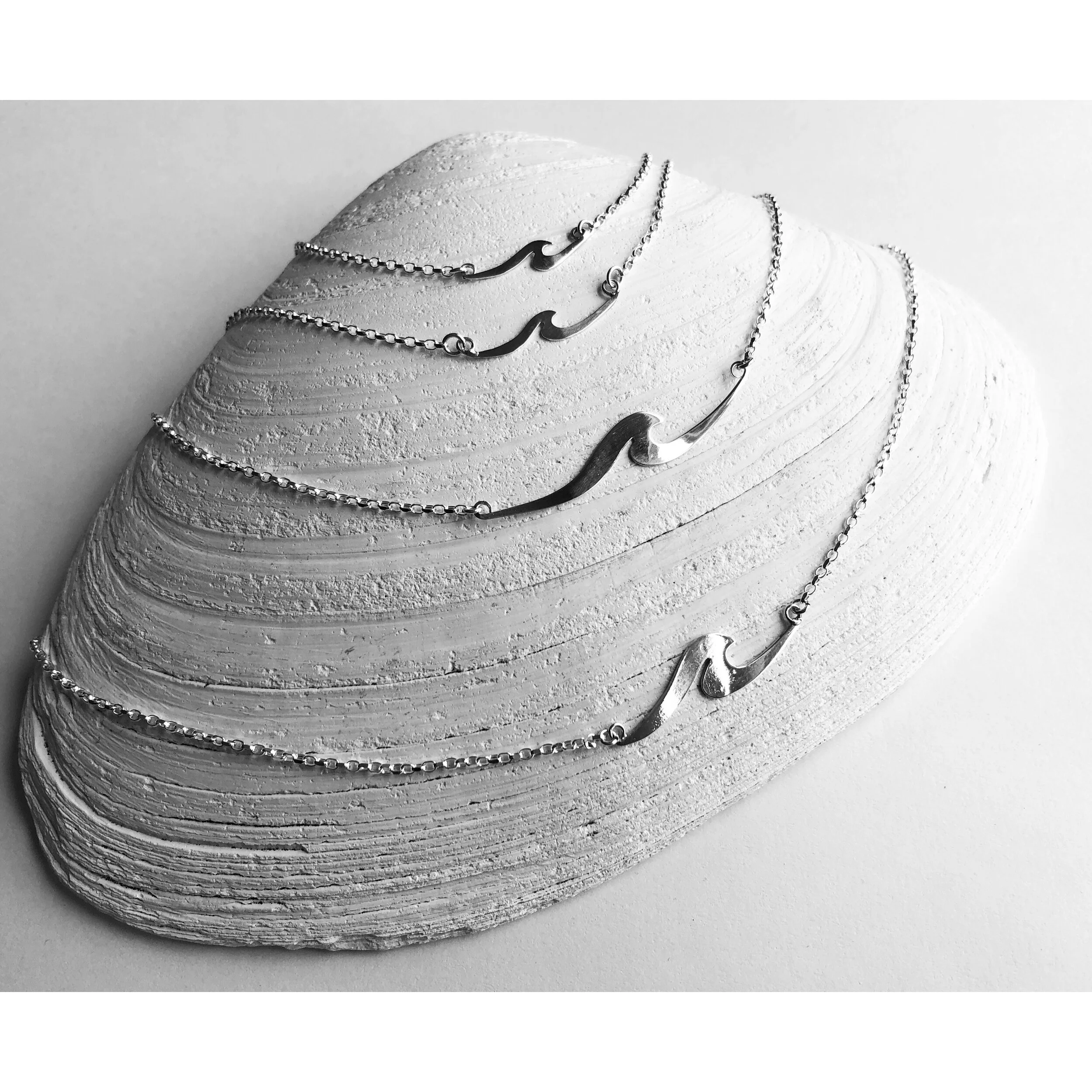wave necklaces on shell.jpg