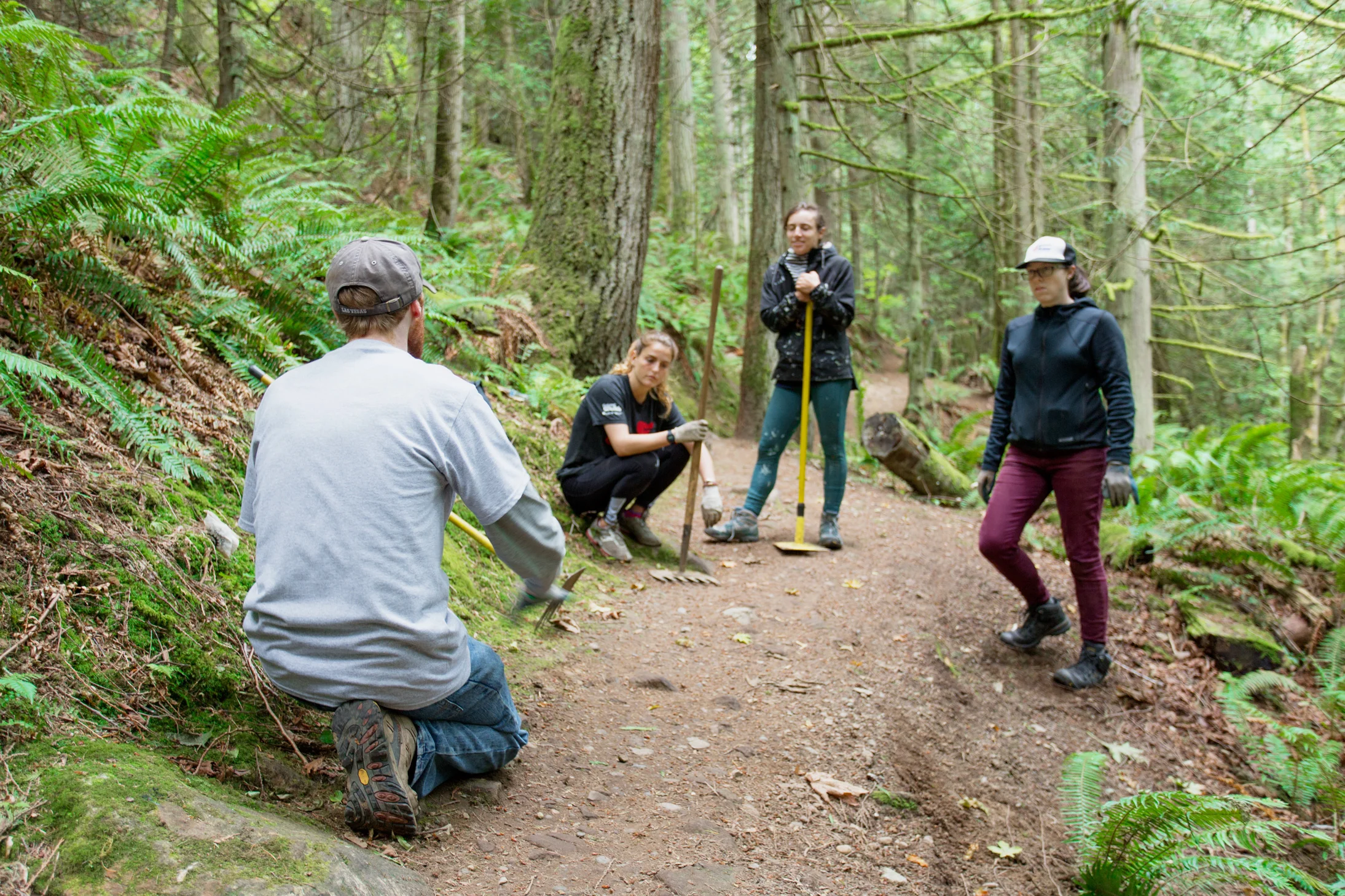 City of Mount Vernon program supervisor, Bret Turner, teaching AmeriCorps VISTA volunteers about best practices for managing drainage along the La-Z-Boy trail at Little Mountain Park.