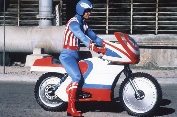 Captain America riding his vintage motorcycle. 