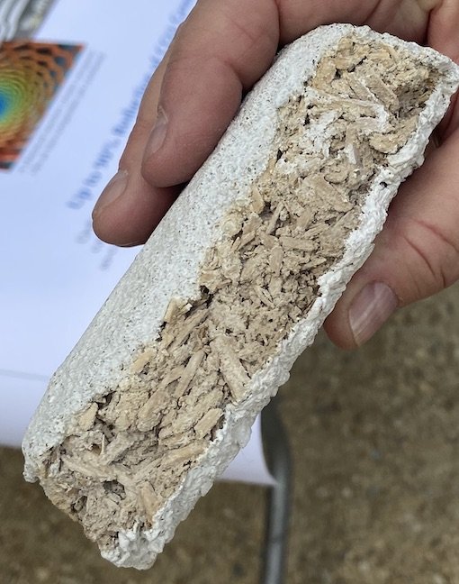  An experimental insulation tile that Jan Thoren, president of NanoArchitech, made by encapsulating hemp hurd in the company's NeuSkyns nanoceramic material. She held the tile for the author to photograph during the 2023 Innovative Housing Showcase i