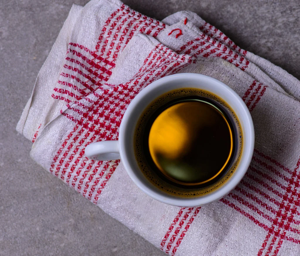 (ts1222) cup of coffee on a white red towel.jpg