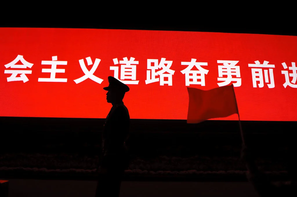 (197) a soldier by a chinese script with flag, tiananmen square, beijing, china.jpg
