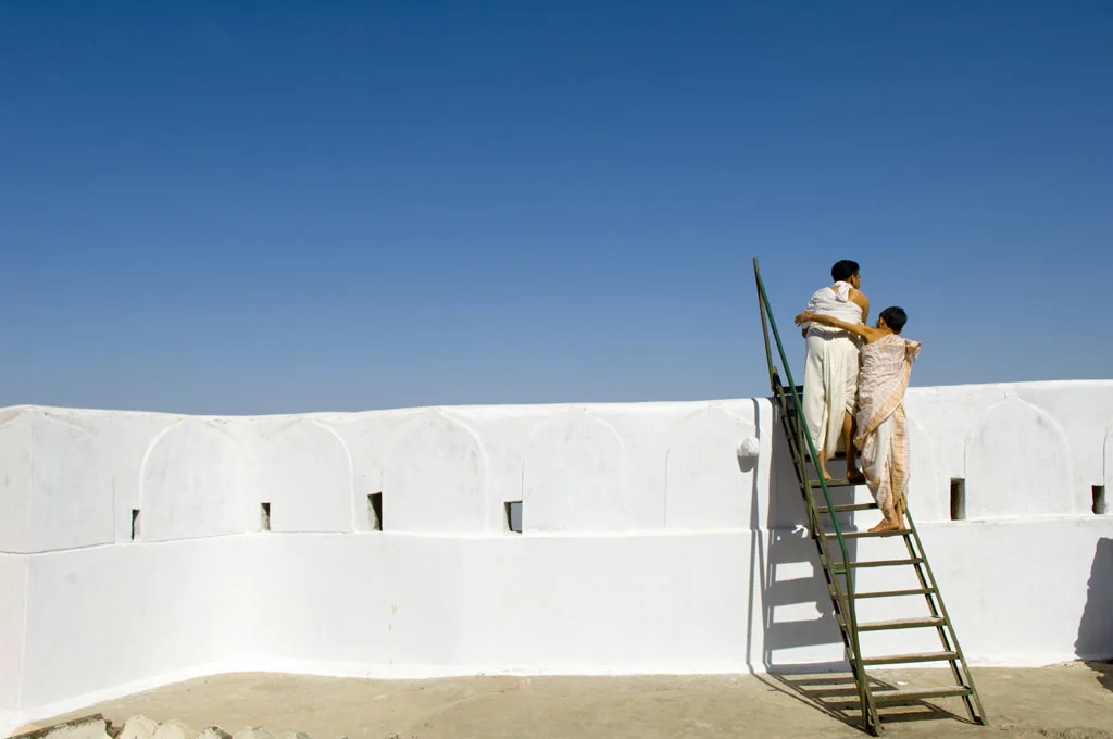 (188) two jain pilgrims climbing a ladder, shatrunjaya, india.jpg