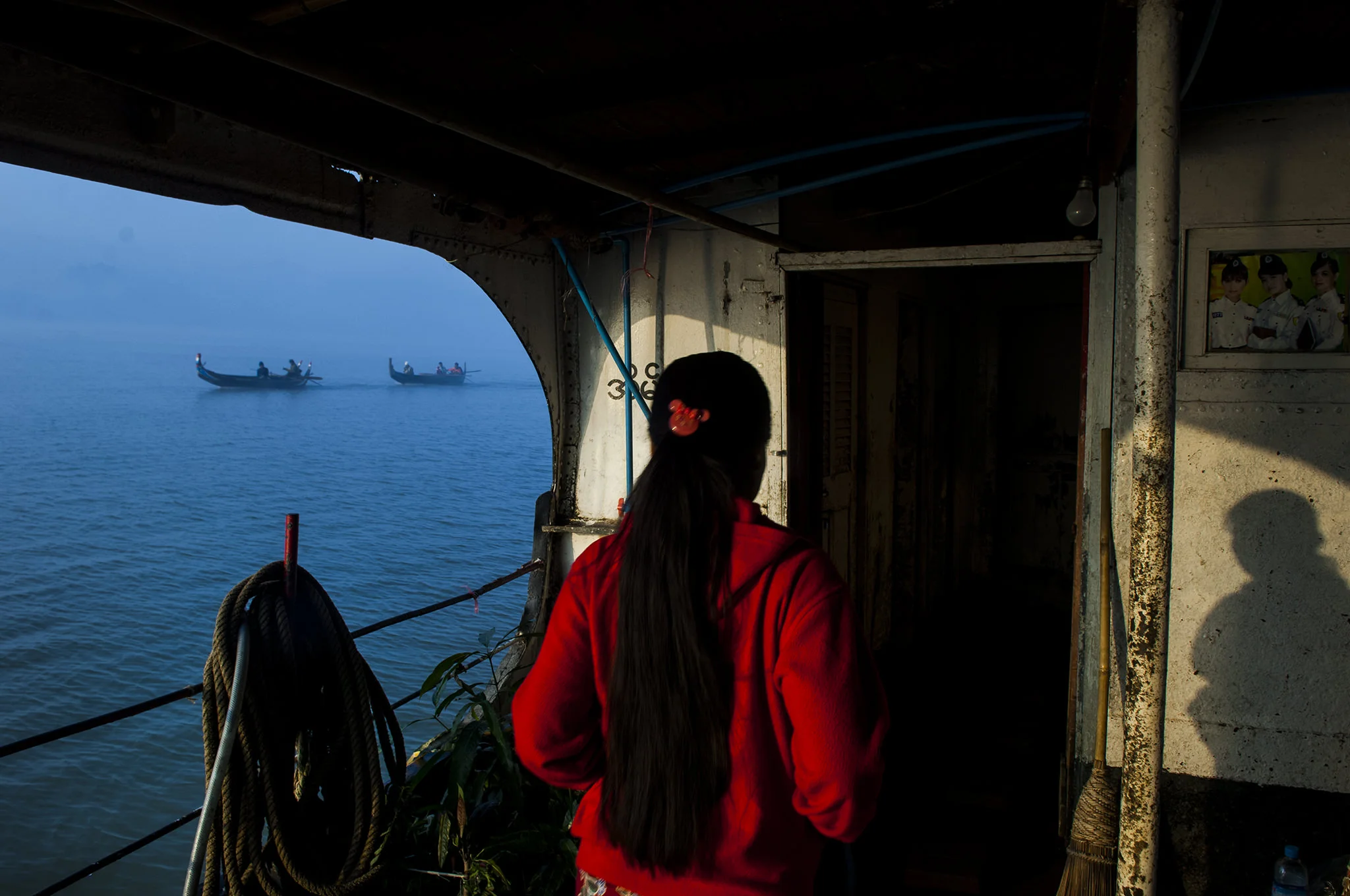 (ts1282) woman in red in a boat burma.jpg