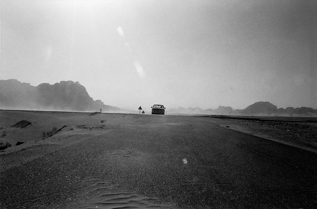 (103) a car waiting in the desert, b&w, jordan.jpg