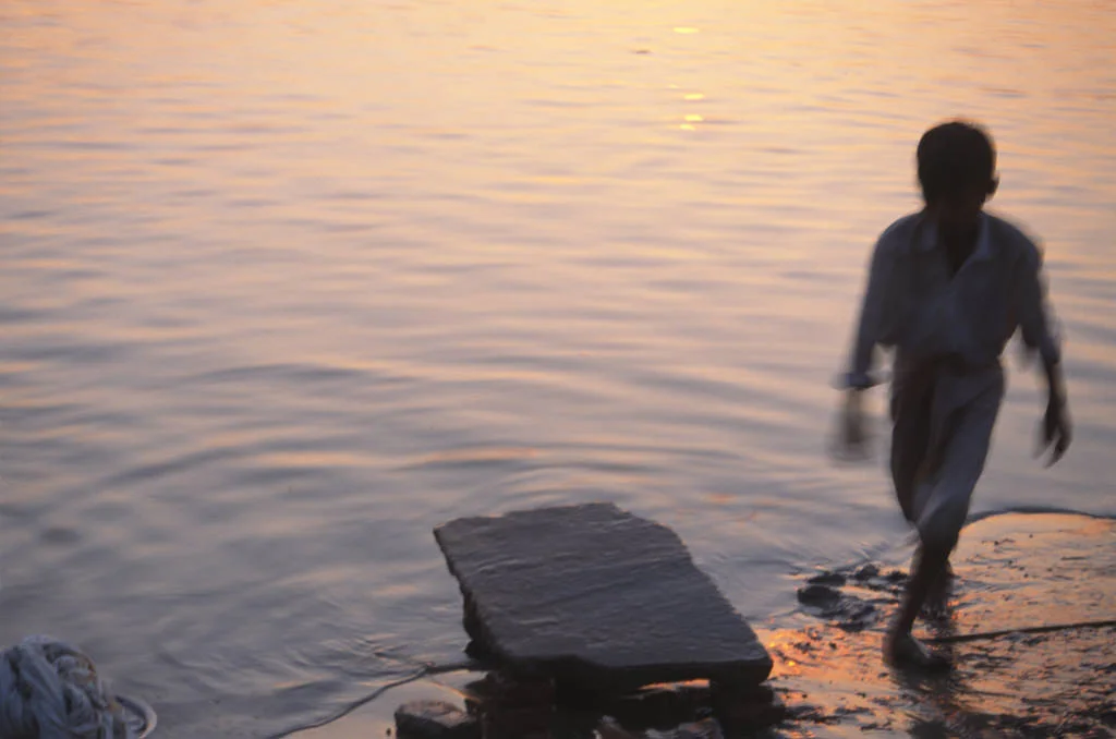 (104) a boy walks by the ganges, india.jpg