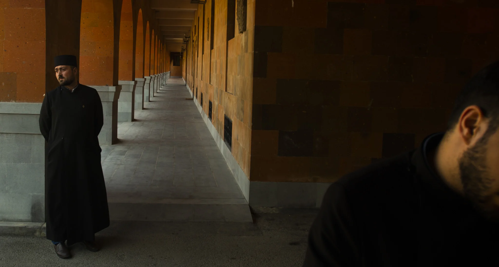a priest standing in etzmiadzin, armenia.jpg