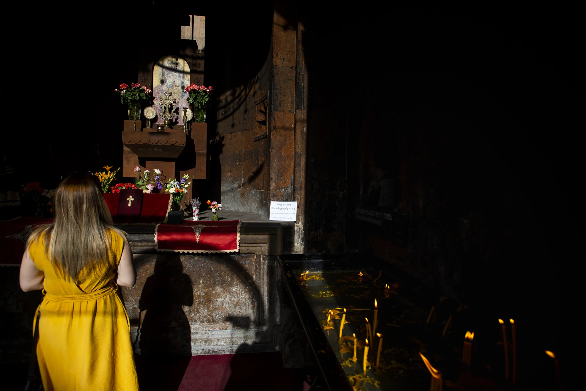 woman in yellow in a church, yerevan, armenia.jpg