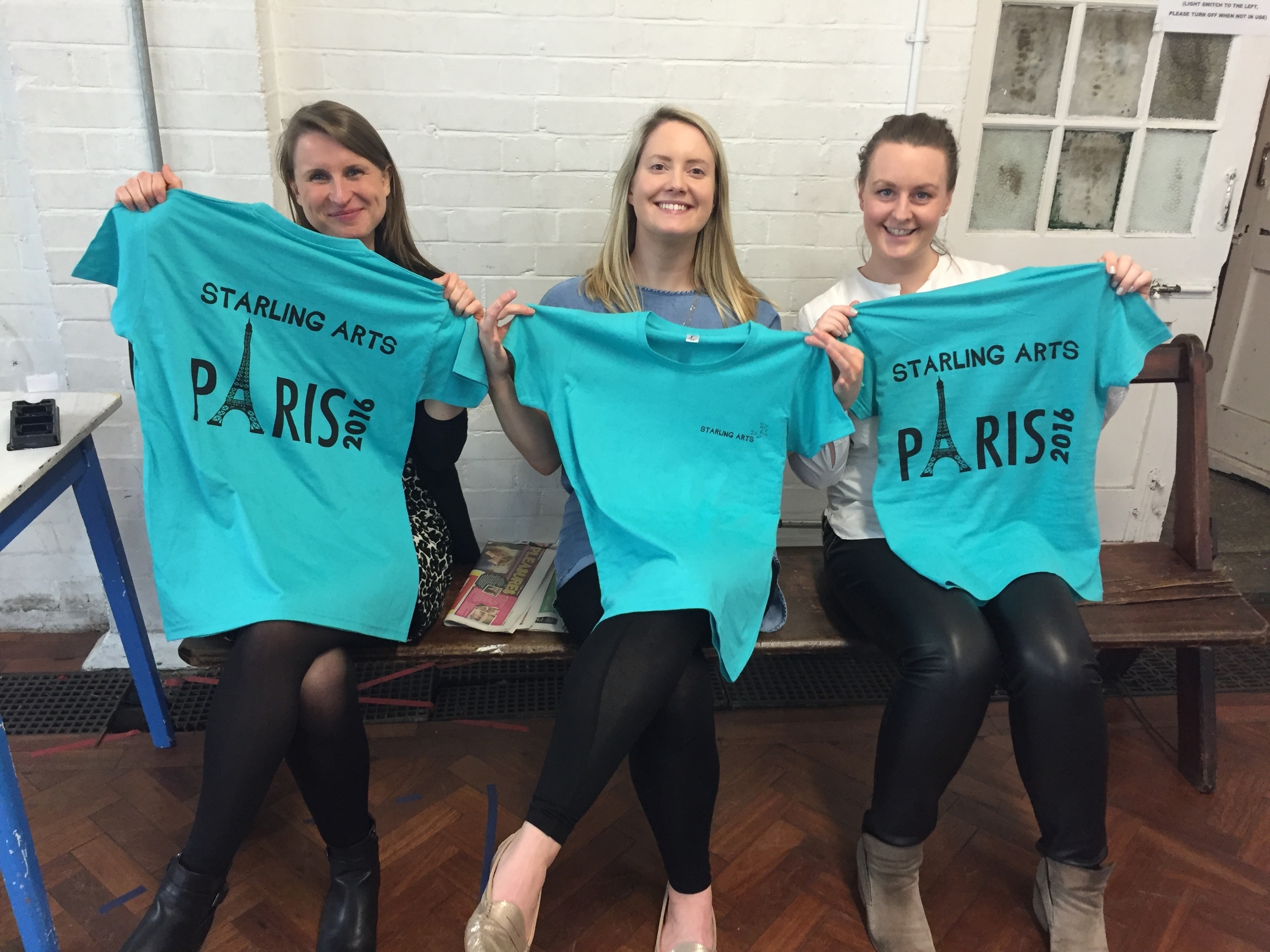 Some of our members show off their special tour t-shirts at rehearsal 