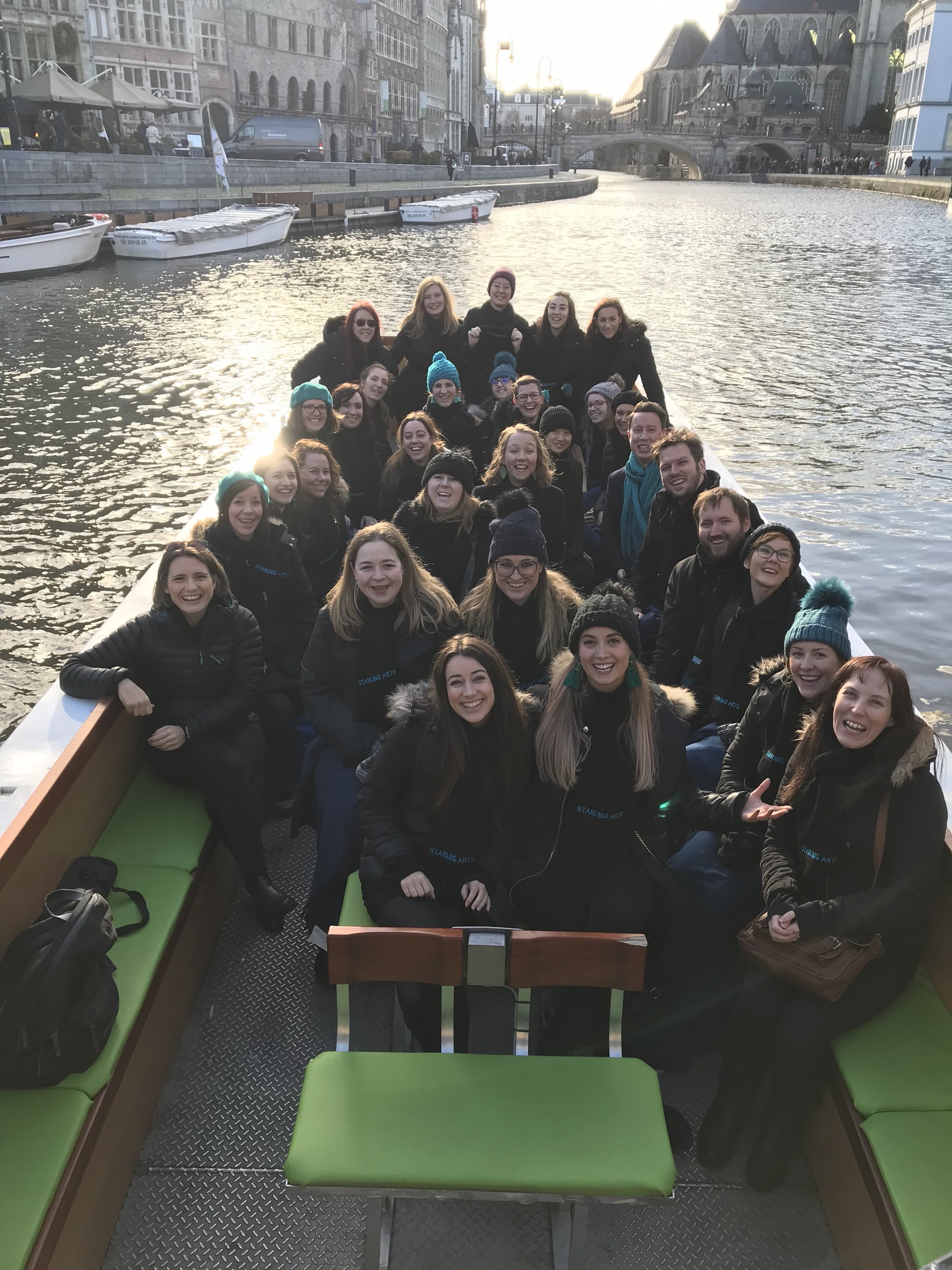 Starling Arts choir members sing on a boat in Ghent 
