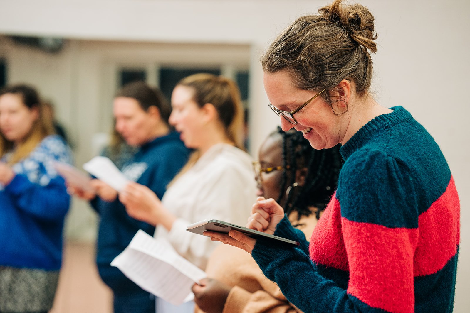 Members of the Starling Voices learn their music in rehearsal