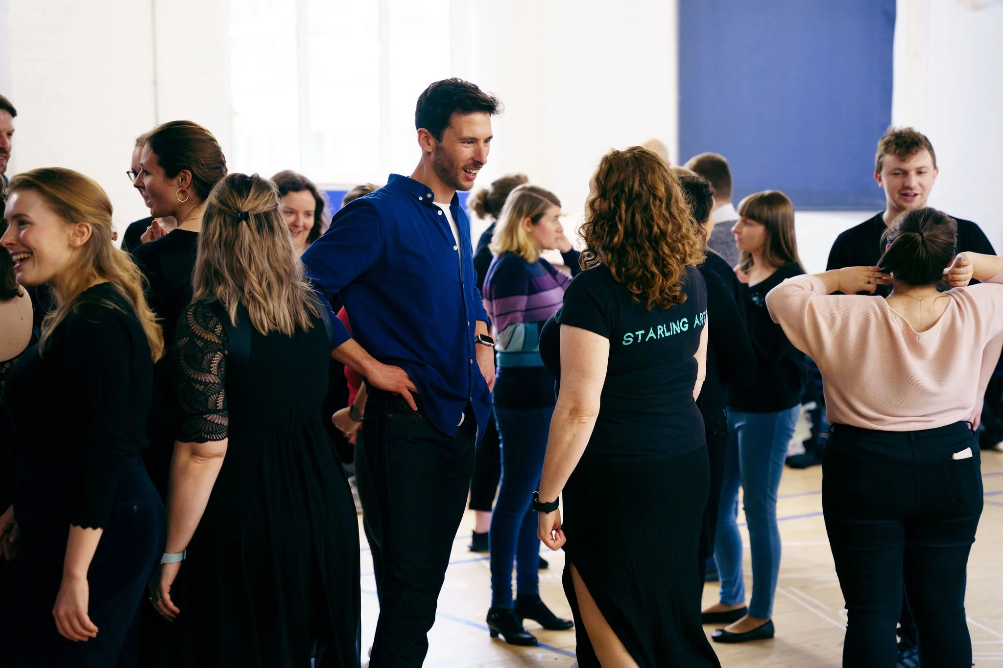 Members of the Starling Voices catch up in rehearsals