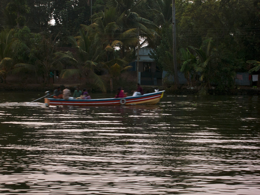 Family in a boat at dusk.