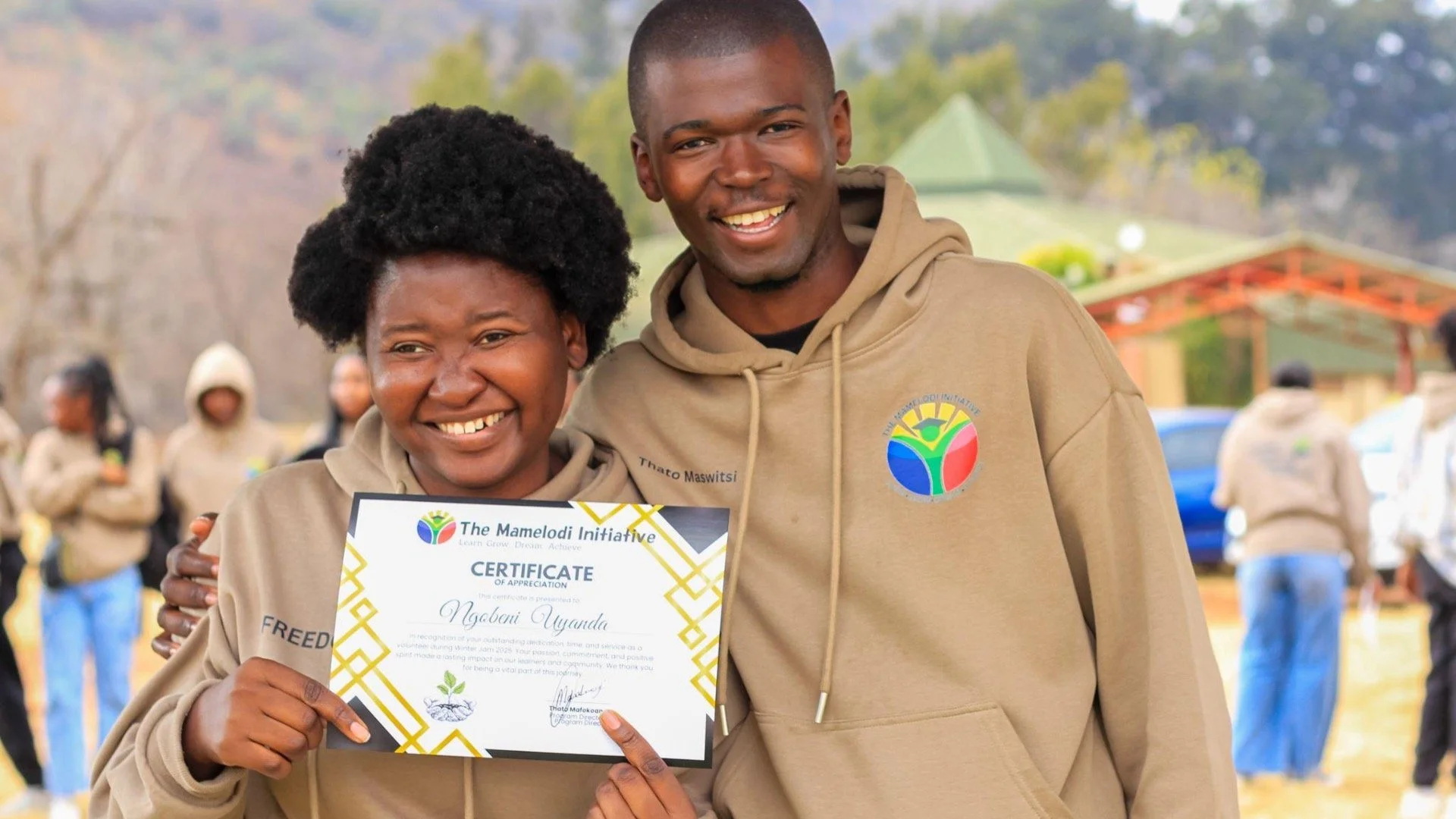 Two people holding a certificate