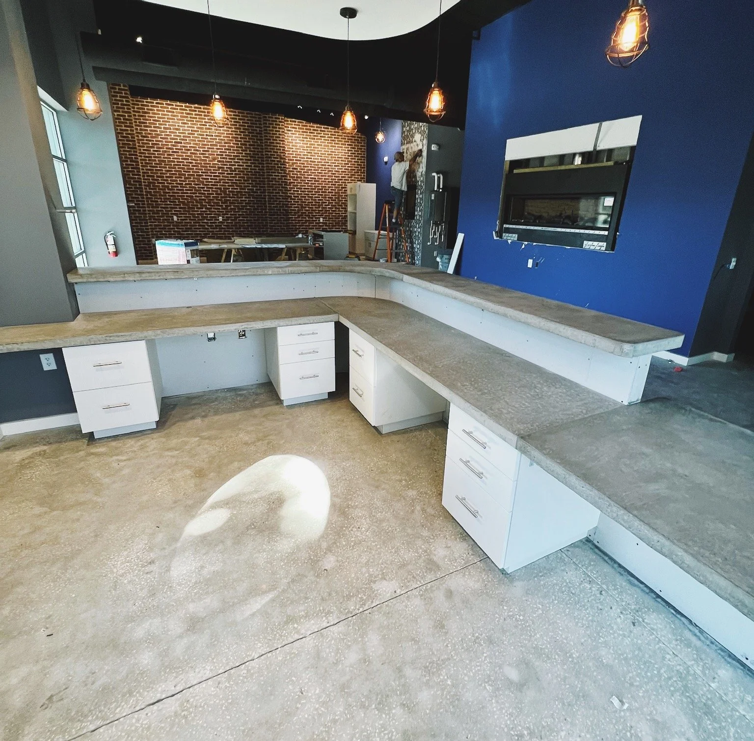 Custom bi-level concrete countertop for business office space