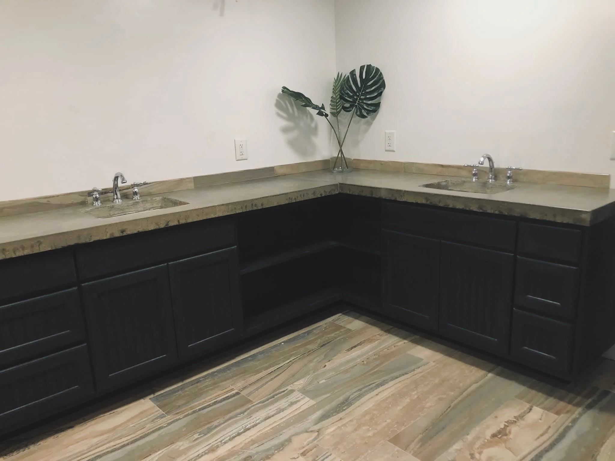 Bathroom renovation with a custom concrete countertop. Dual drop-in sinks.