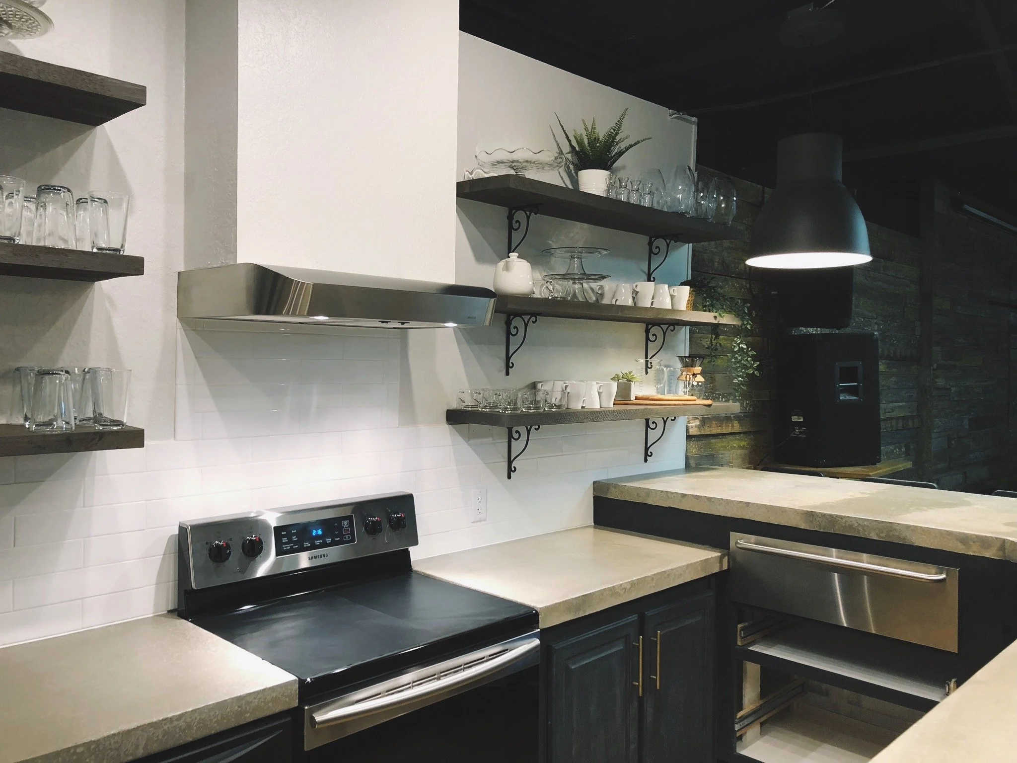 Custom concrete countertop and island, wooden floating shelves